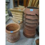 Four terracotta garden planters to include a vented chimney pot planter