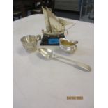 Four items of silver to include a model ship on stand and a tablespoon, total weight 238.3g