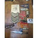 A mixed lot of cloth badges, knives, and a trench art cigarette case to include a Palestine