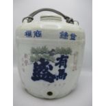 A 1920's Japanese Saki barrel and lid with moulded woven ornament decorated with pine trees and