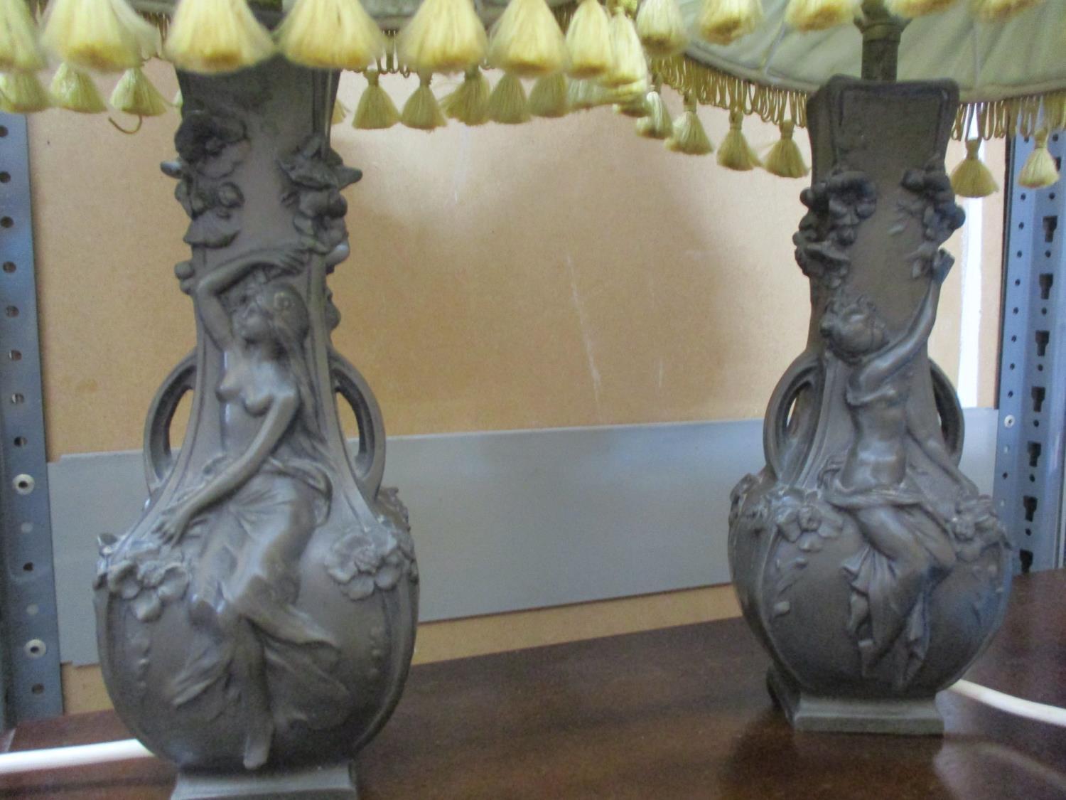 A pair of resin table lamps in the style of Art Nouveau twin handled pewter vases, (lamp shades A/