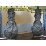 A pair of resin table lamps in the style of Art Nouveau twin handled pewter vases, (lamp shades A/