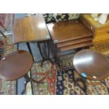 A reproduction nest of three mahogany tables, a pair of reproduction mahogany wine tables, and an