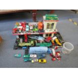 A tin plate vintage model garage with various Dinky, Matchbox and other diecast model vehicles,