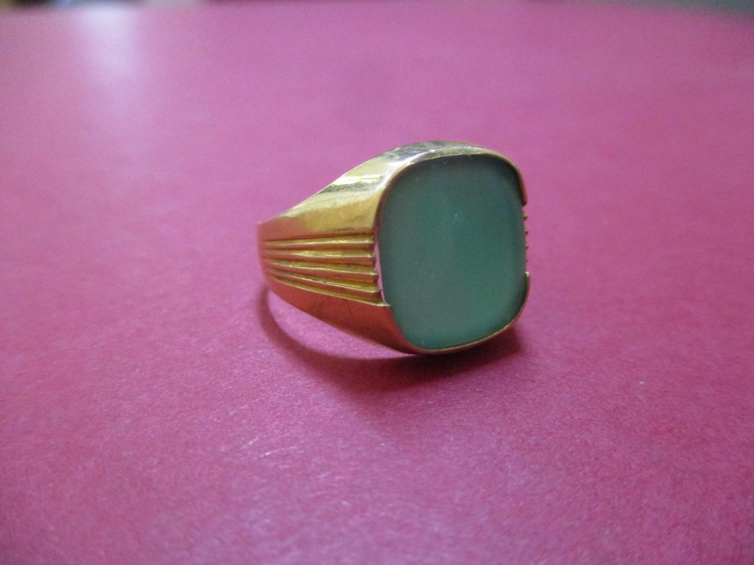 A 14ct gold gents signet ring set with a green stone, total weight 5.4g