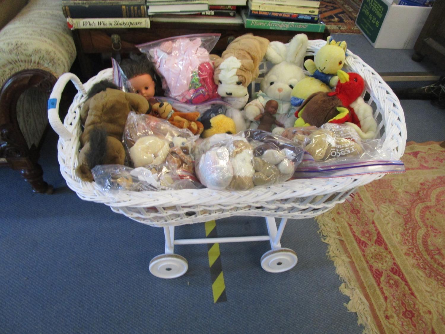 An early 20th century white painted wicker crib basket on wooden stand, a wicker child's peacock