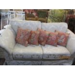 A modern two seater sofa, pouffe and armchair in a cream damask style fabric, together with eight