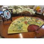 A modern Oriental decorative oversized fan, together with an Oriental table top screen depicting