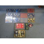 A collection of coin sets, crowns, and commemorative crowns to include a Great Britain Year Type set