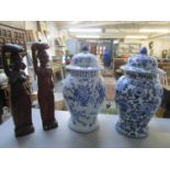 Two late 20th century oriental blue and white temple jars and covers (A/F), and two Asian carved