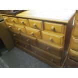 A modern pine bank of fourteen drawers 35 1/2" H x 49 1/4" W