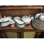 A Royal Doulton Earlswood dinner and tea service decorated in gilt to include two tureens, dinner