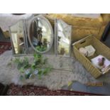 A silver painted trifold dressing table mirror, a grey sheepskin rug, and a basket of