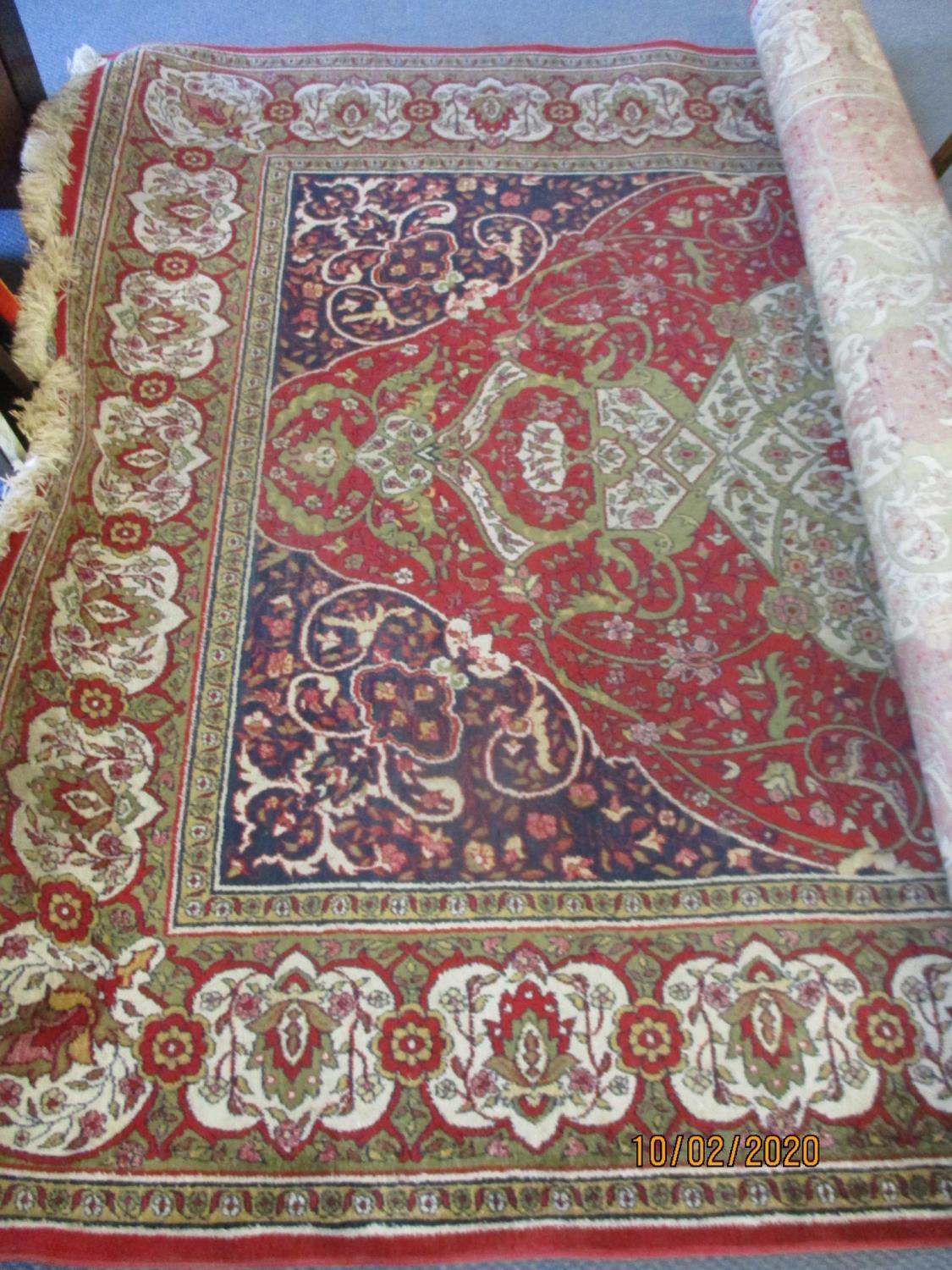 A Kermon machine made carpet with a central medallion and flowers on a red ground Location: FSR