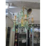 A Continental gilt metal framed six-branch chandelier with green and clear drops and swags
