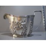 A Victorian silver embossed cream jug