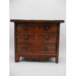 A Victorian satinwood string inlaid mahogany traders sample chest of three drawers, with turned