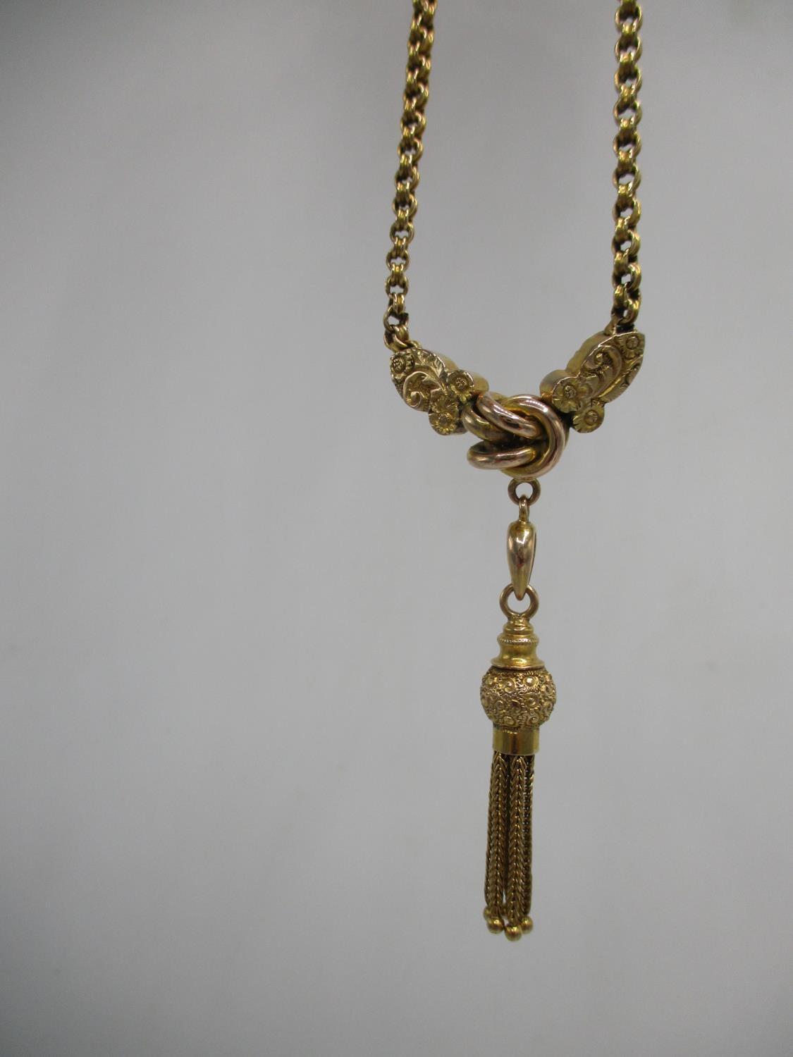 A Victorian 9ct gold necklace with a double link, a knot flanking by twin engraved floral panels and