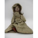 A 19th century Grodnertal style peg doll with a pink painted face, a glass eye, (one missing) and