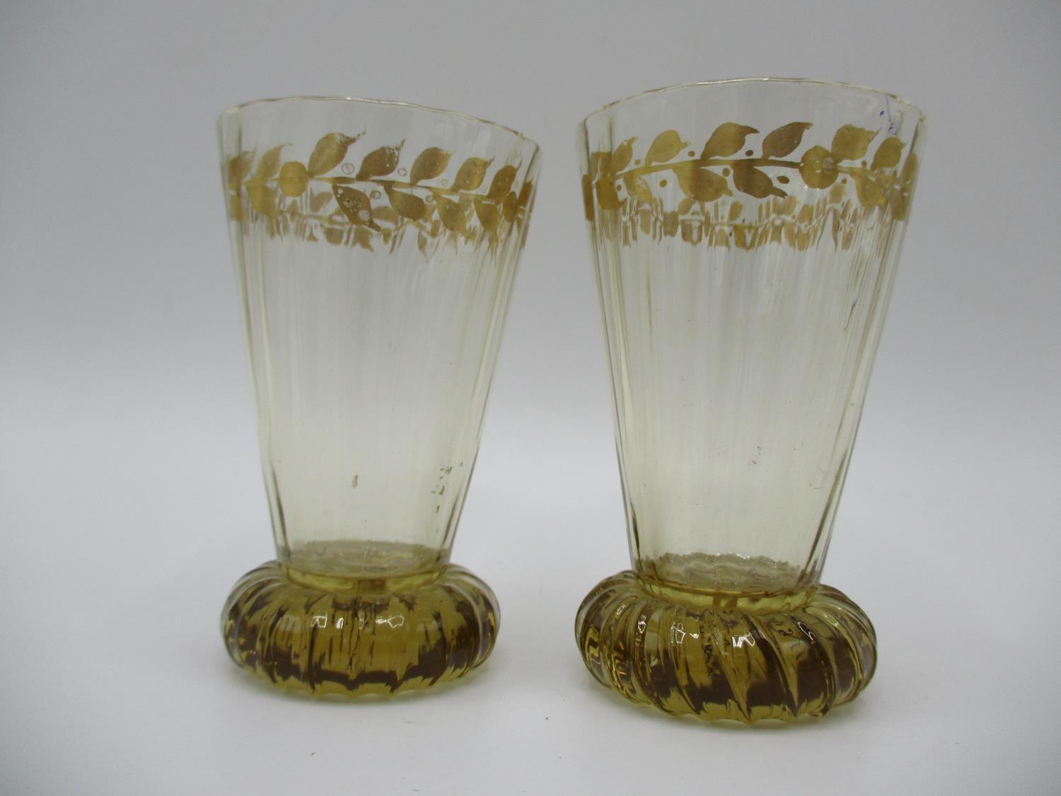 A pair of late 19th century Galle glasses with a tapered, ribbed body decorated with a fruiting