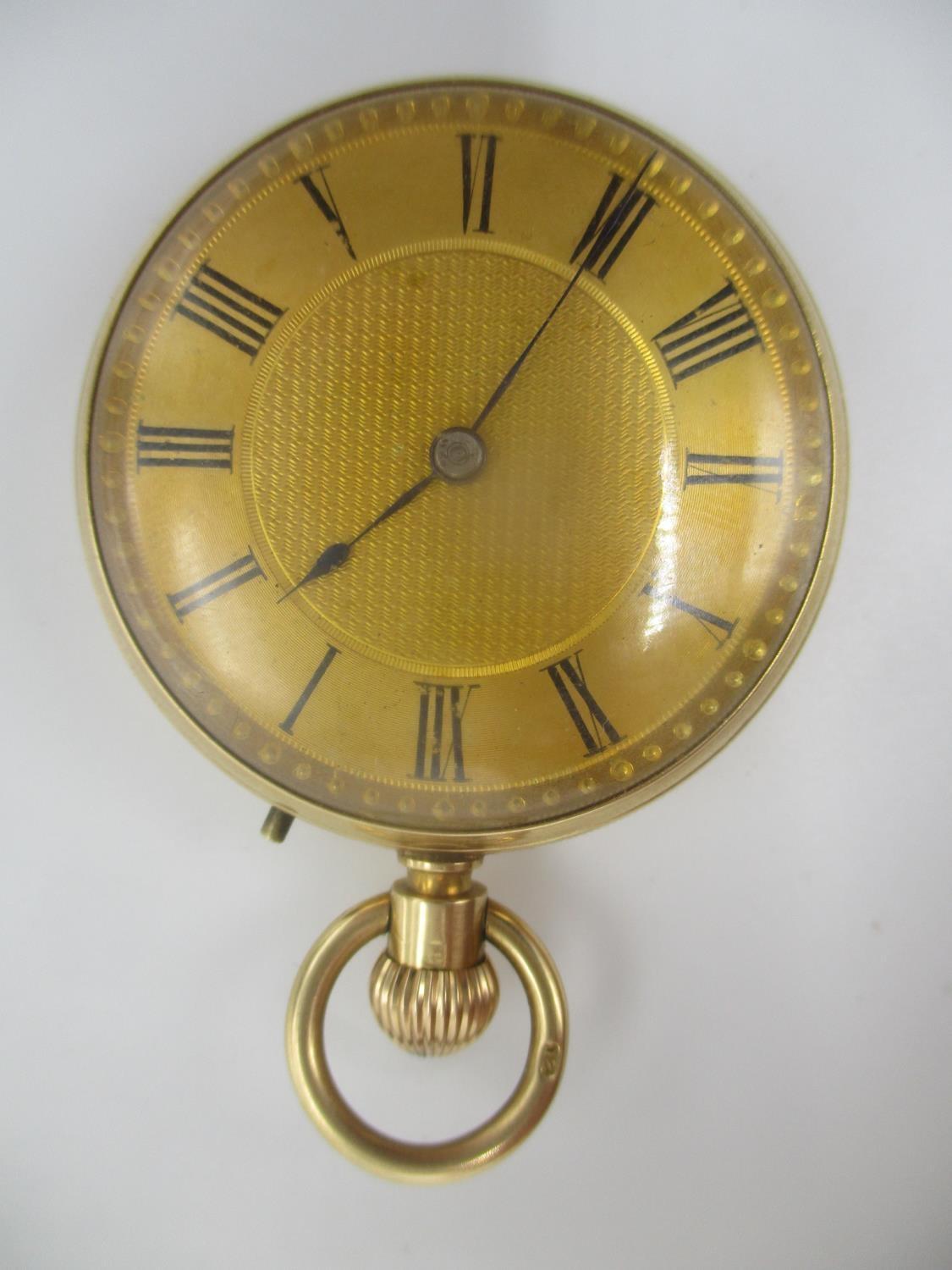 A late 19th/early 20th century 18ct gold open faced, keyless wound fob watch having a machine turned