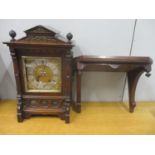 A late 19th/early 20th century German bracket clock with wall bracket. The walnut case having gilt