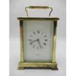 A late 10th century brass ceased carriage clock, the white enamel dial having Roman numerals and