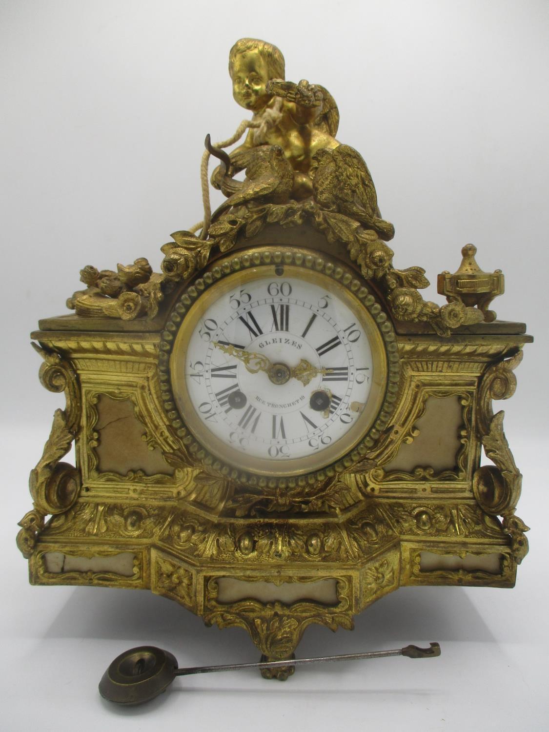 A mid/late 19th century French gilt metal mantle clock decorated with a cherub to the top with two