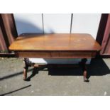 A Regency rosewood sofa table with a pair of frieze drawers, over carved, scrolled ends, on