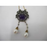 A gold and silver pendant set with a cabochon amethyst, seed pearls and diamonds surmounted by a bow