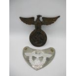 A WWII German Third Reich iron NSDAP wall plaque with an eagle perched on a wreath, 7 1/2"h and a