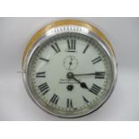 An early 20th century ships clock having a white dial with Roman numerals, the dial inscribed John