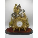A late 19th century French gilt metal mantle clock decorated with a man on horseback, armour and