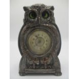An early 20th century Arts & Crafts silver plated fronted mantle clock modelled as an owl with