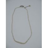 A natural pearl necklace with a gold clasp set with diamonds