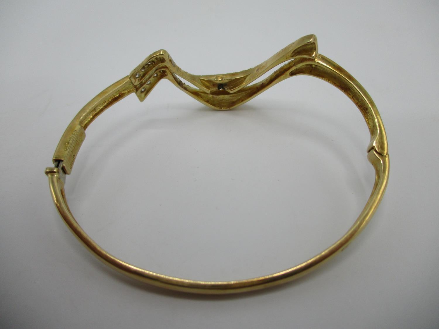 An 18ct gold coloured metal hinged bracelet of wave design set with fifty two diamonds, stamped - Image 3 of 7