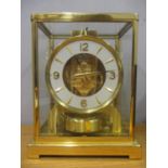 A Jaeger Le Coultre Atmos clock circa 1960, in a gilt brass case, the cream chapter ring with