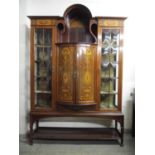 An Edwardian Taylor and Hobson mahogany and extensive marquetry inlaid display cabinet with a
