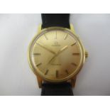 An Omega gold plated gents manual wind wristwatch having a gilt dial with central seconds, on a