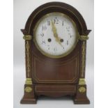 A late 19th century mahogany 8 day, arched top mantle clock having a white enamel dial with Arabic