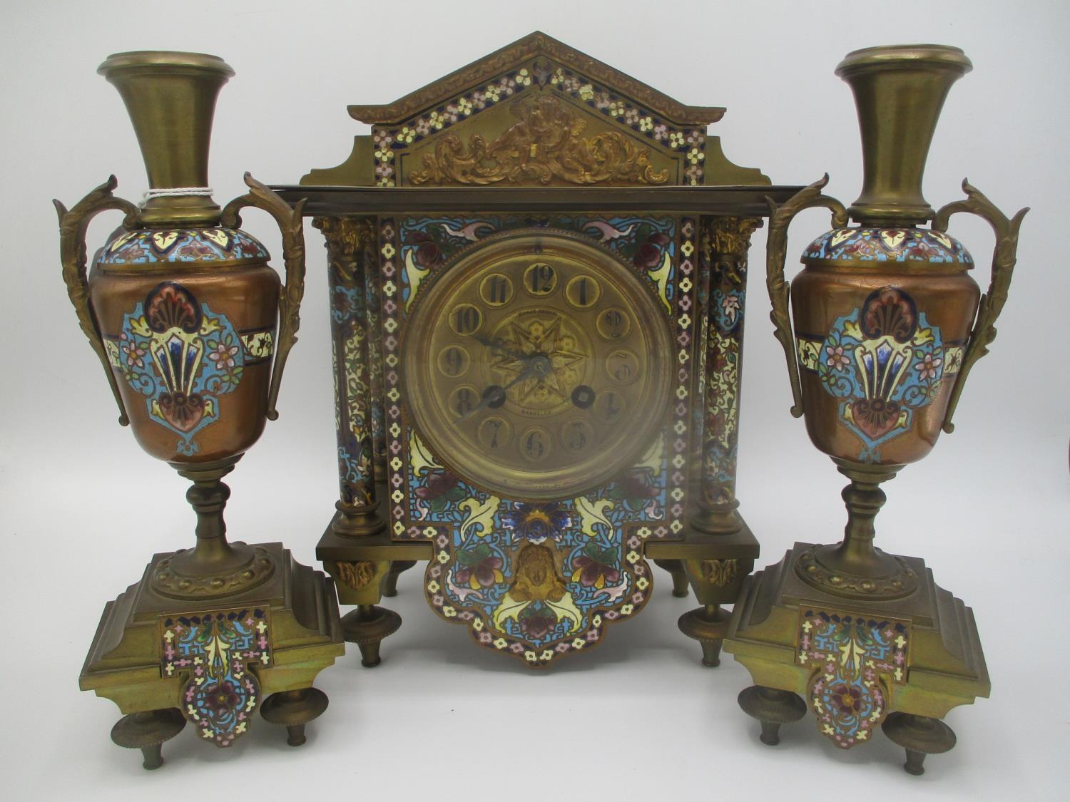 A late 19th century gilt metal cloisonne clock garniture set, the clock of architectural form having