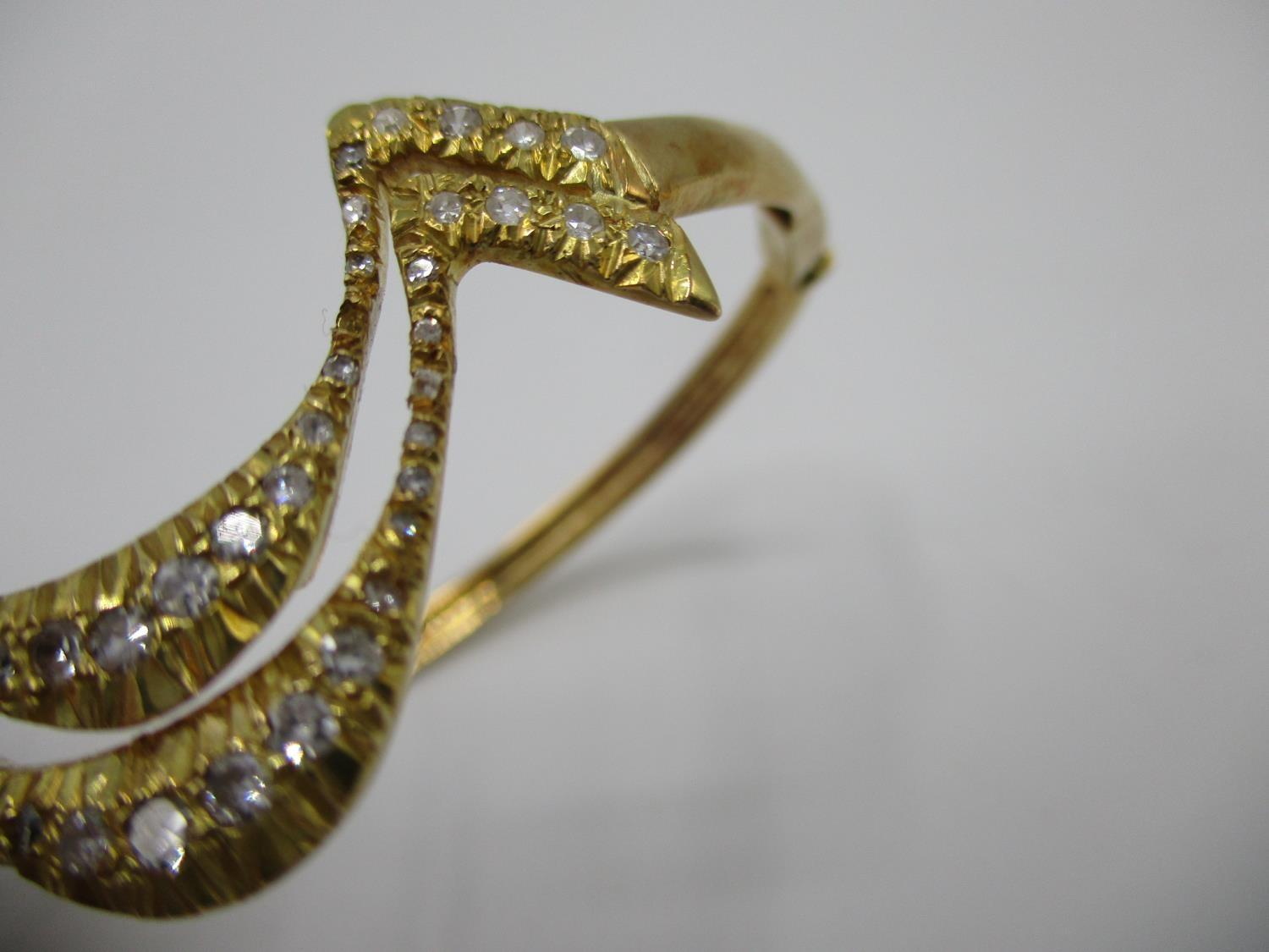 An 18ct gold coloured metal hinged bracelet of wave design set with fifty two diamonds, stamped - Image 2 of 7