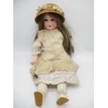 An early 20th century German bisque headed doll stamped A.75 with closing eyes, open mouth and