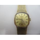 A Tissot ladies 9ct gold manual wind wristwatch having a gilt dial with baton markers, integral