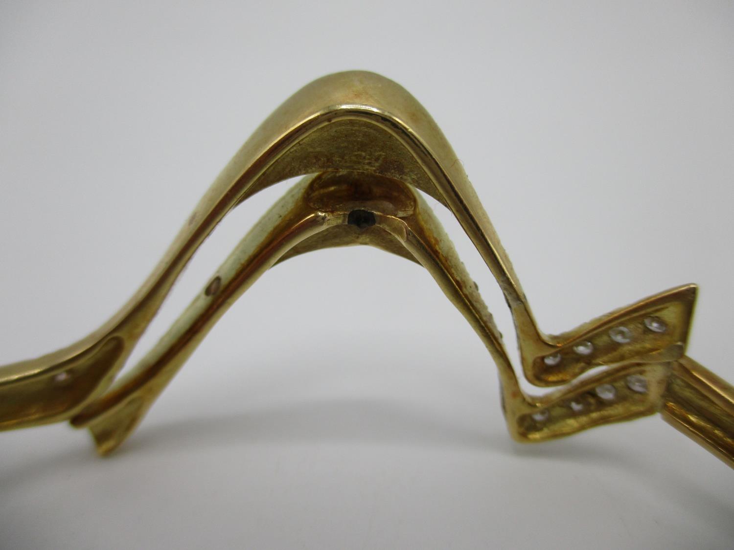 An 18ct gold coloured metal hinged bracelet of wave design set with fifty two diamonds, stamped - Image 4 of 7