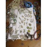 A quantity of silver charms, mainly animals, together with earrings and mixed costume jewellery