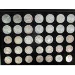 A cased lot of silver coins to include a part set of British commemorative Commonwealth coinage
