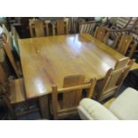 A South African hardwood square formed dining table, together with a set of eight chairs signed '