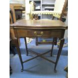 An Edwardian walnut swivel and folding top card table with single drawer on cabriole legs, united by