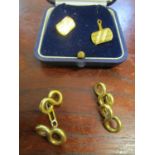 A pair of 9ct yellow gold cuff links and a pair of yellow coloured cuff links
